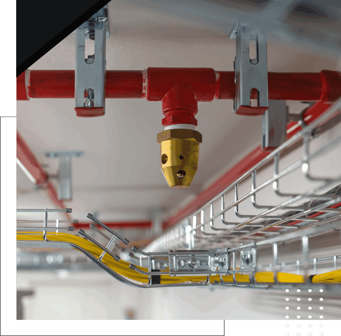 Fire sprinkler system with red valve in industrial setting.